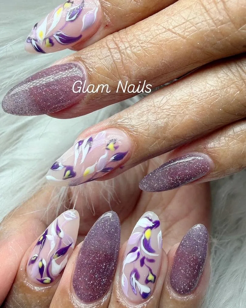 Purple glitter almond nails with white iris and leaf floral art